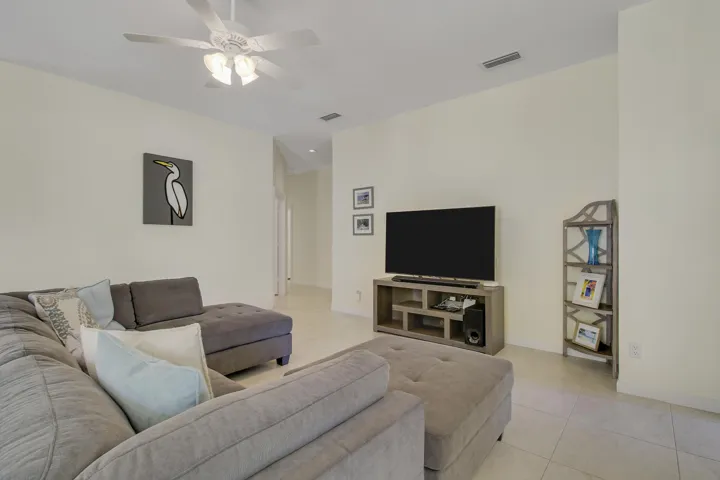 Recessed lighting, tile flooring, ceiling fan, and light-toned walls