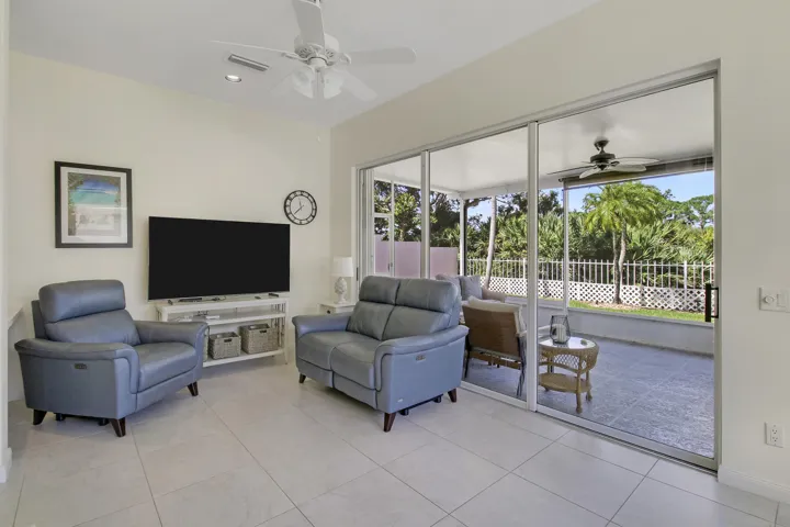 Porcelain tile flooring, recessed lighting, and a ceiling fan