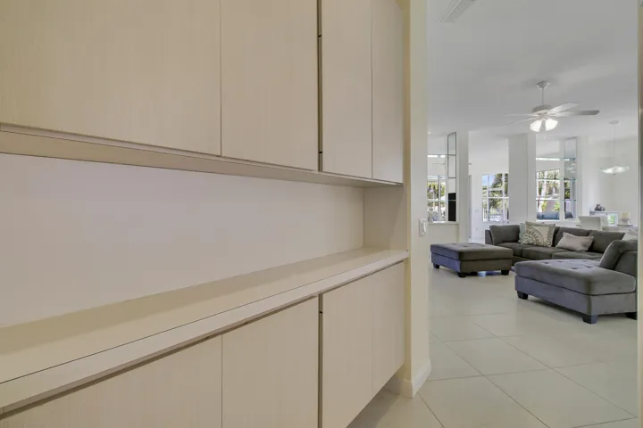 Built-in cabinetry with light-toned finishes in hallway - great storage!