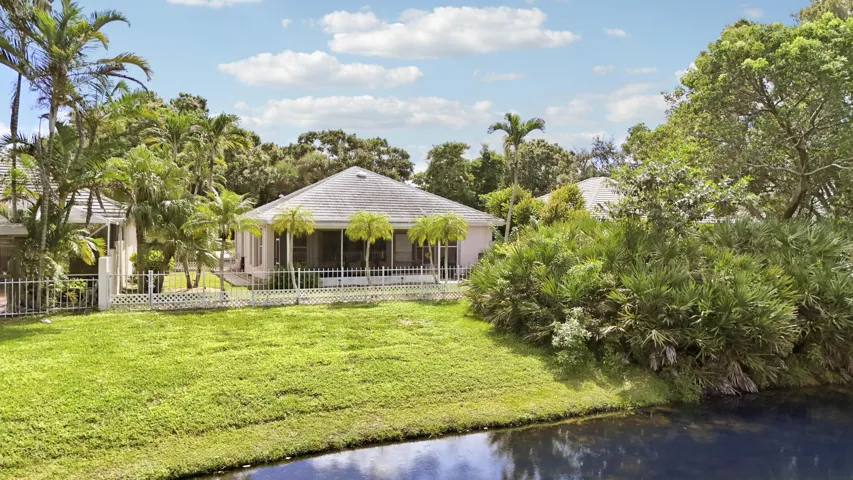 Lakefront with mature trees and lush landscaping