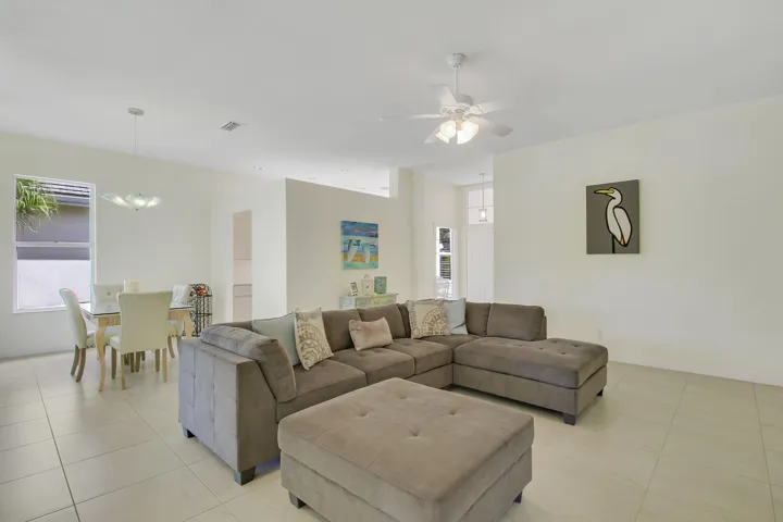 Large living area featuring a ceiling fan, recessed lighting, and tile flooring