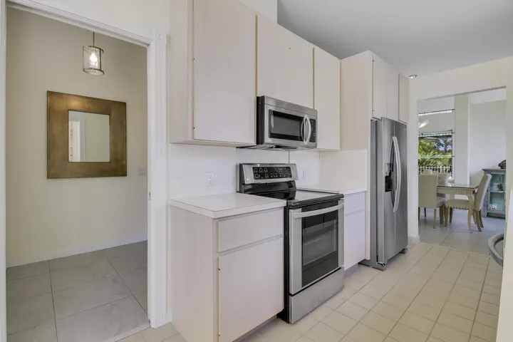 Kitchen featuring light-toned cabinetry and countertops, and stainless steel appliances