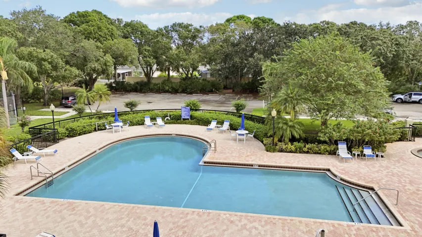 Large community pool with a surrounding paver deck