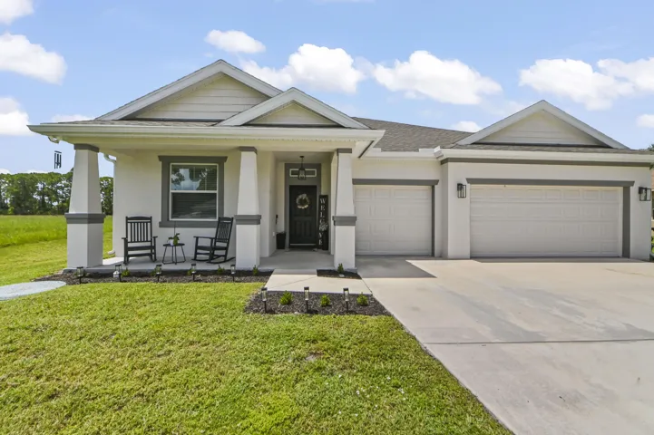 Inviting porch at entry with 3 car garage to accommodate 6 or more cars