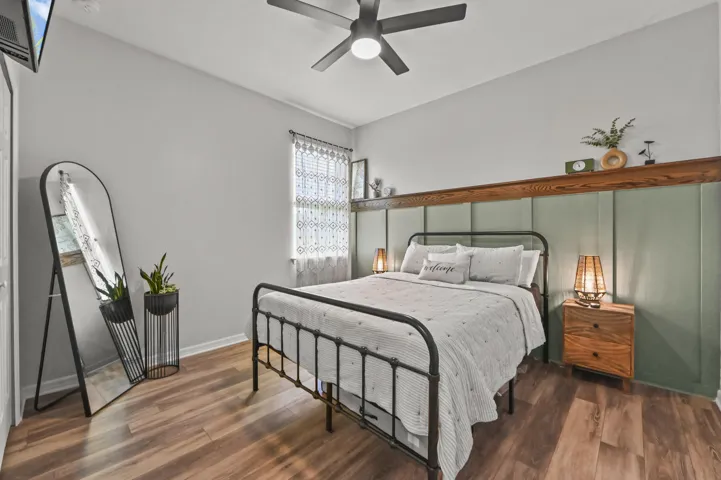 Spacious guest bedroom with wood style floors