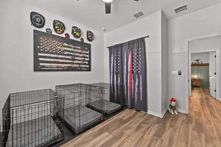 Converted den into a 5th bedroom with wood style flooring and ceiling fan