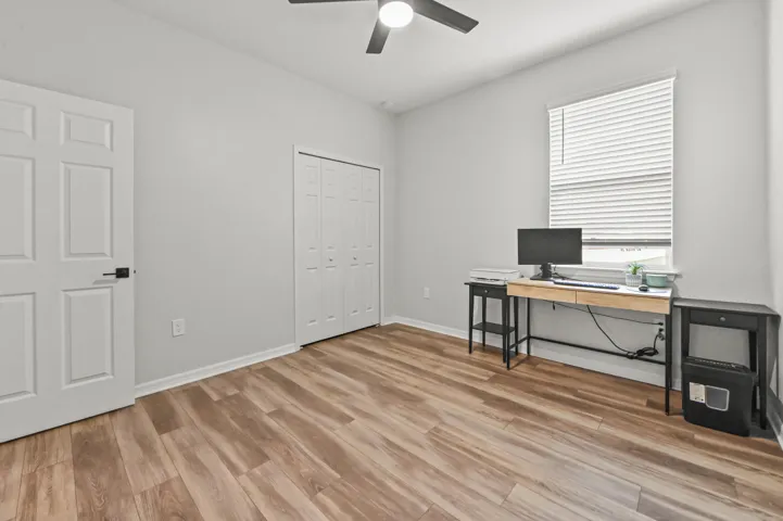 Bedroom #4 being used as office area with ceiling fan and wood style flooring