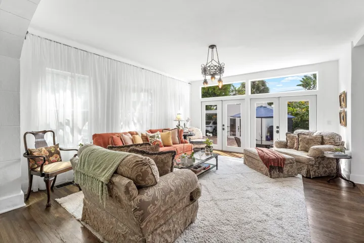 Family room, with high ceilings, and doors to the pool deck.