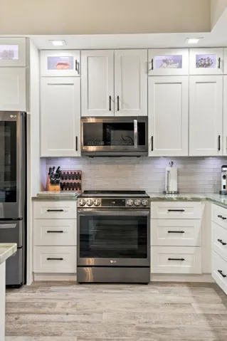 LG Black Stainless Instaview Electric Range – knock twice on glass to light up interior. Notice the above and below cabinet lighting (hard-wired and can change colors)