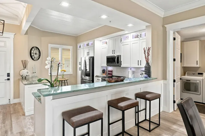 Large breakfast bar with three bar stools.