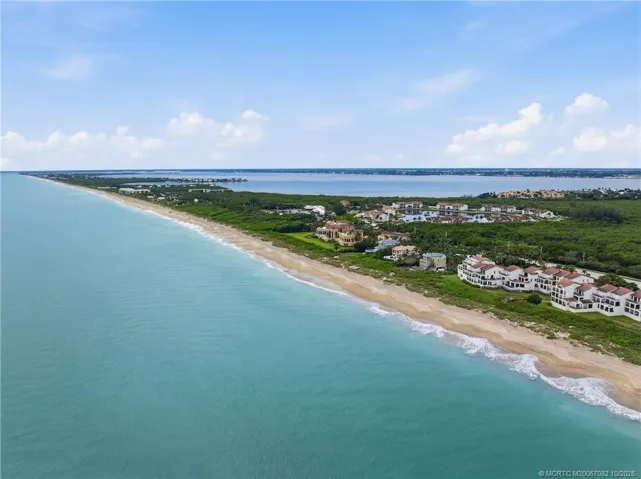 Expansive aerial perspective showcases miles of coastline with the Atlantic Ocean and Indian River framing Hutchinson Island.