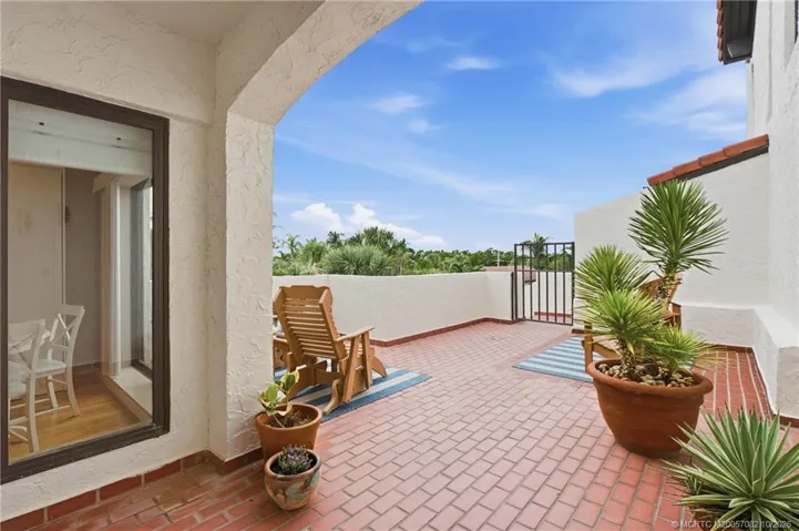 Large open-air courtyard with multiple seating areas and tropical landscaping.