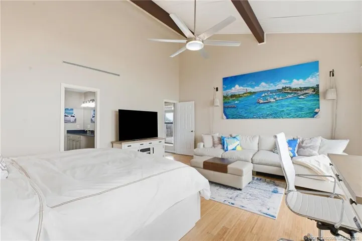 The oversized primary suite offers plenty of room for a sitting area and workspace, along with a private bath and ocean views.