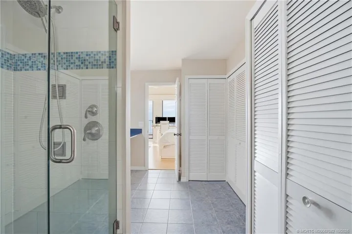Spacious primary bath offers generous closet storage and a large walk-in shower, with direct access to the primary suite.