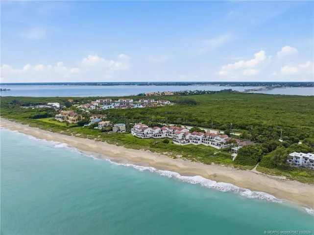 Sweeping aerial view captures the Atlantic shoreline, The Dune, and the Indian River beyond.