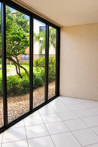 Sunlit Screened Patio with Garden Views