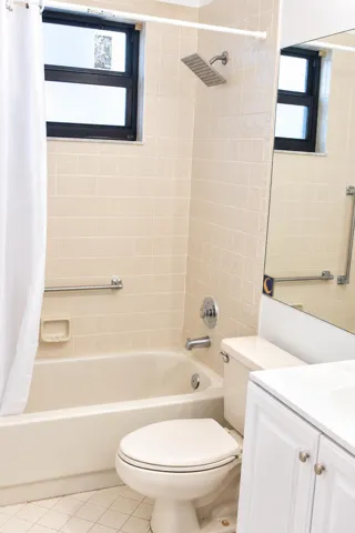 Bright Neutral Bathroom with Tub and Van