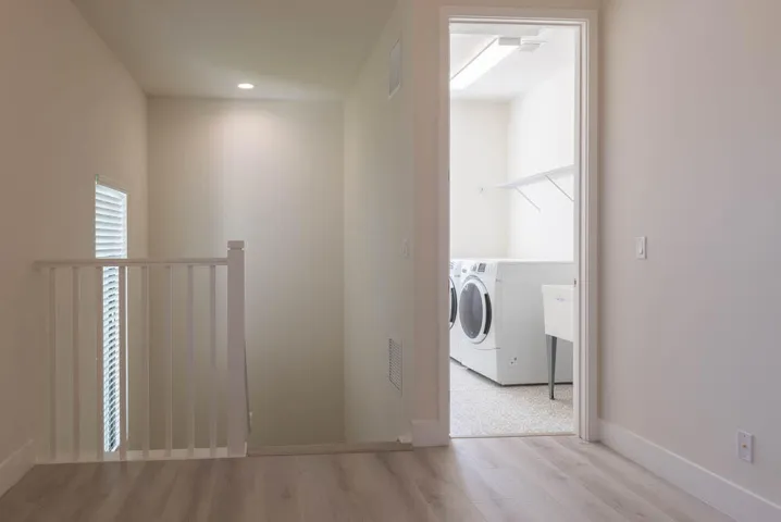 Laundry area with built-in shelving and utility sink
