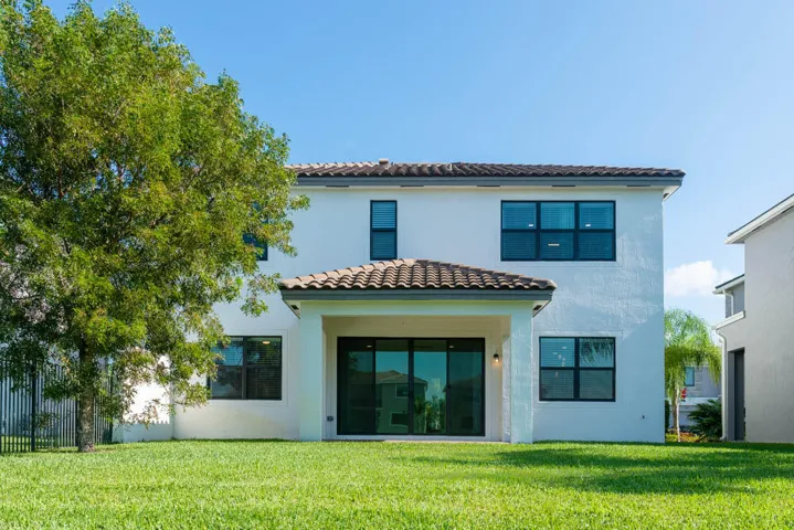 Expansive green lawn featuring a large tree