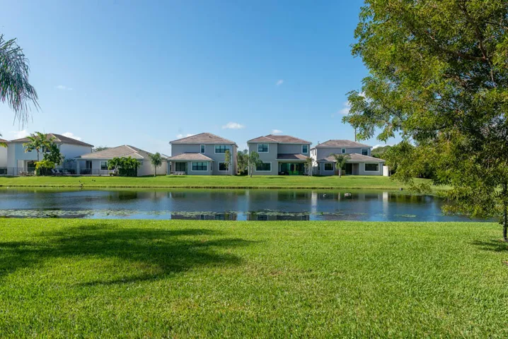Manicured lawn extending to a tranquil pond