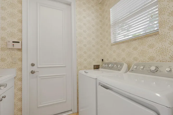 Dedicated laundry room w/laundry tub/cabinets overhead