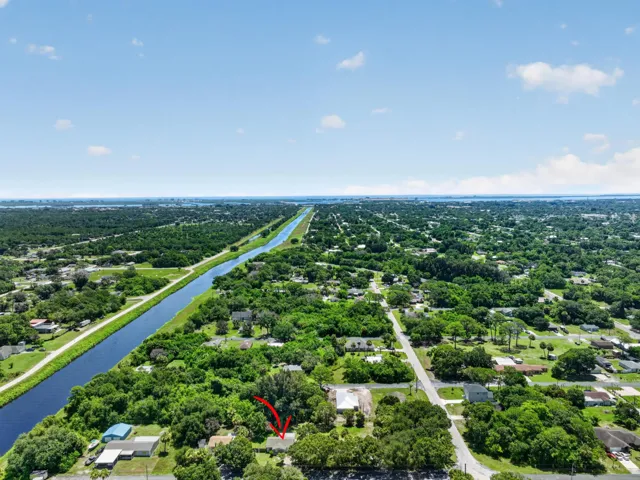 Aerial perspective showcasing a residential area with extensive tree coverage