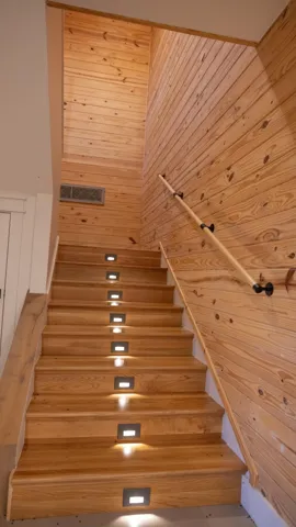 Wood-clad walls complementing the natural wood staircase