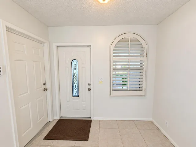 Brightened front entry, faithfully prese