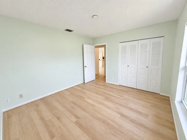 Brightened mint bedroom, clutter removed