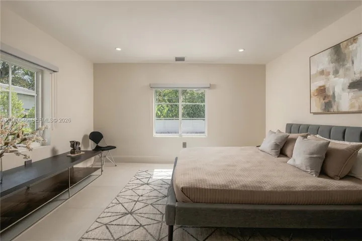 Spacious Bedroom 2 with pool view.