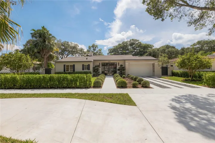 Front of house with circular drive and driveway.