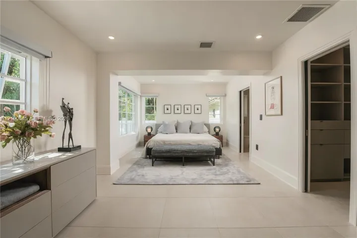 Sunlit Primary Bedroom with direct pool access.