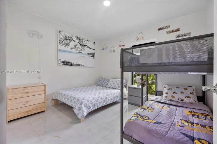 White walls and light-toned tile flooring create a bright interior