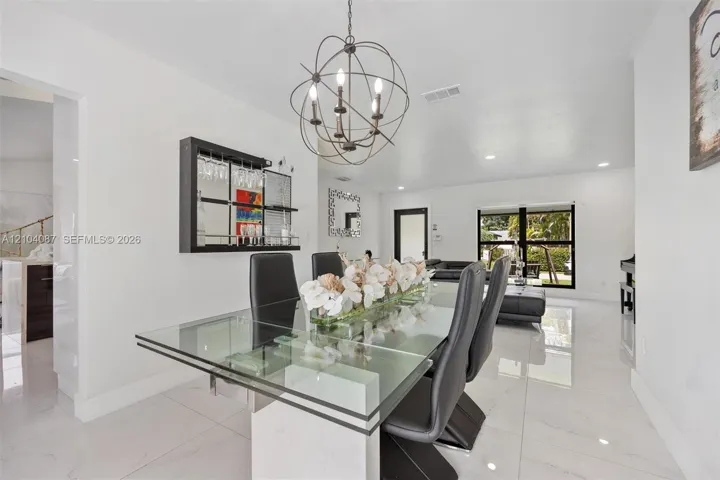 White tile flooring throughout, with a glass-top dining table