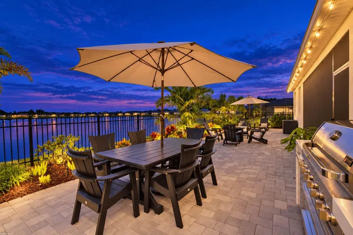 Outdoor dining beneath an umbrella at twilight