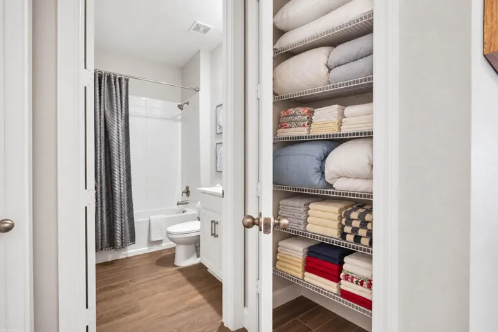 Guest bath and linen closet with built-in shelving