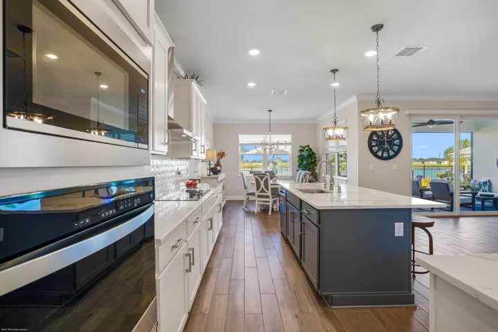 Kitchen with wall ovens and open view to the great room