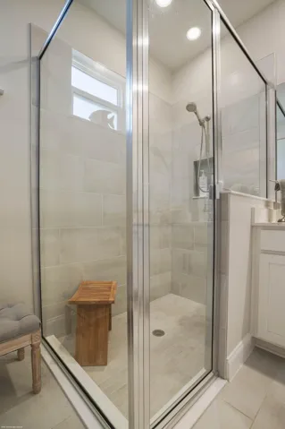 Walk-in shower with glass enclosure