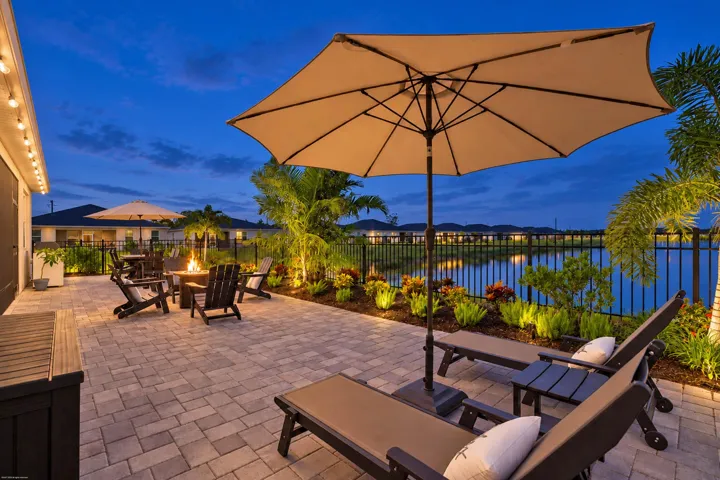 Paver patio with lake views at twilight