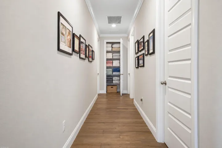 Gallery hallway with wood-look plank flooring