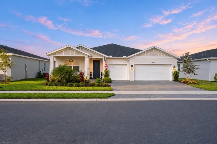 Front elevation at dusk with paver driveway