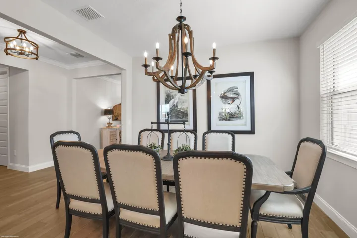 Dining table beneath a statement chandelier