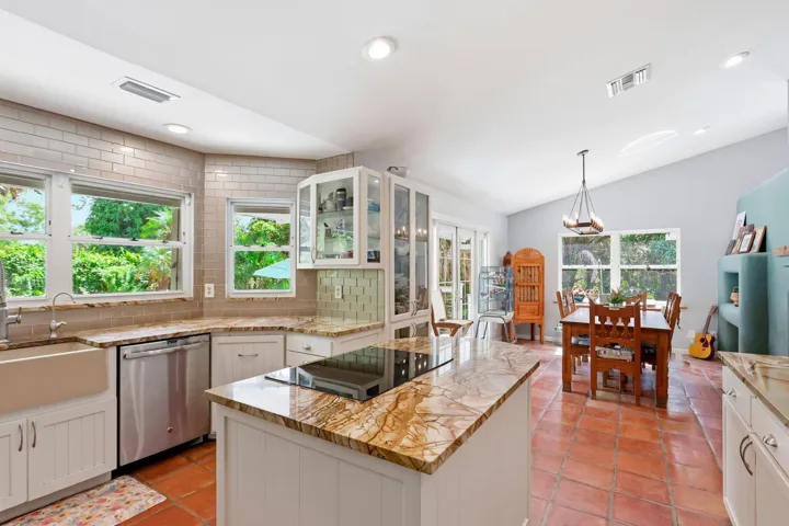 With bay windows that overlook the pool and connect to the dining room