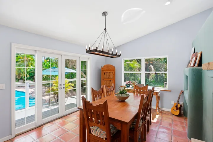 Terracotta tile flooring, vaulted ceiling, and recessed lighting