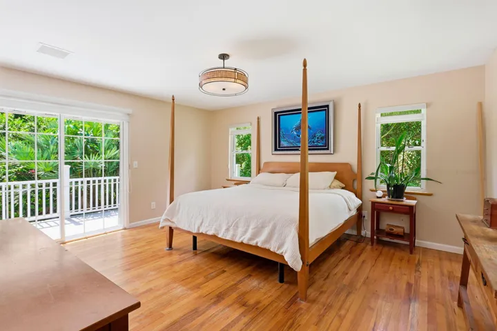 Oak wood flooring and sliding glass door to a private porch