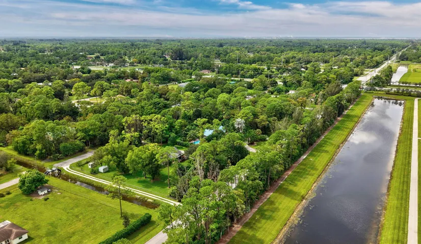 Expansive property featuring mature trees and lush green landscaping