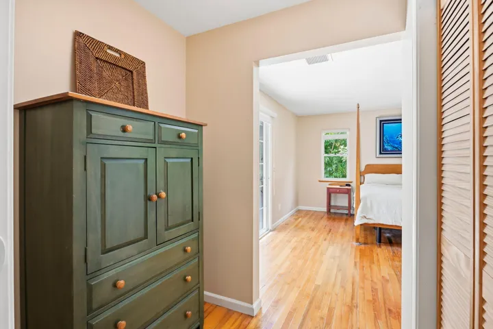 Hardwood-style flooring extends through the room, complemented by neutral wall tones