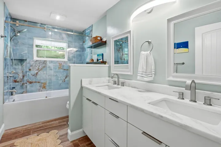 Dual vanity with white cabinetry and integrated sinks