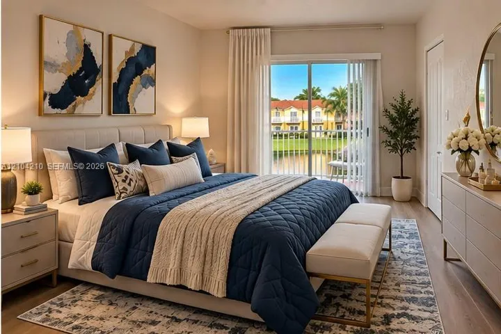Sliding glass doors opening to a balcony, wood-finish flooring, and a neutral wall color