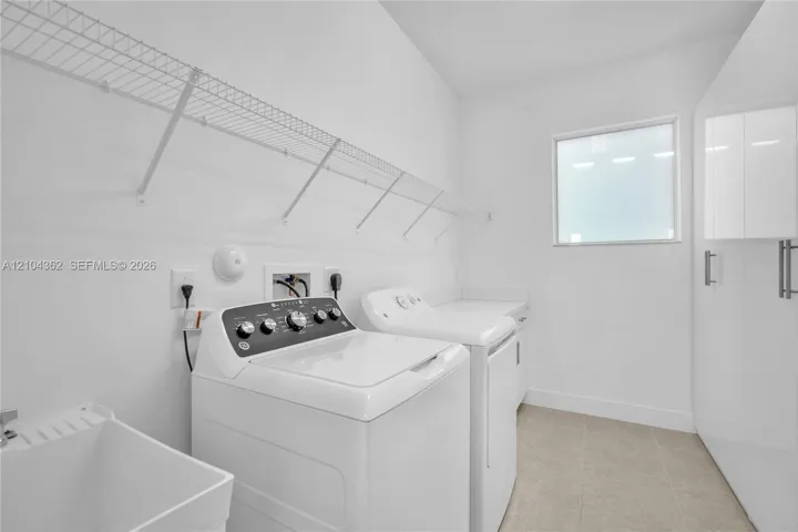 With utility sink, counter top folding cabinet and custom closets.